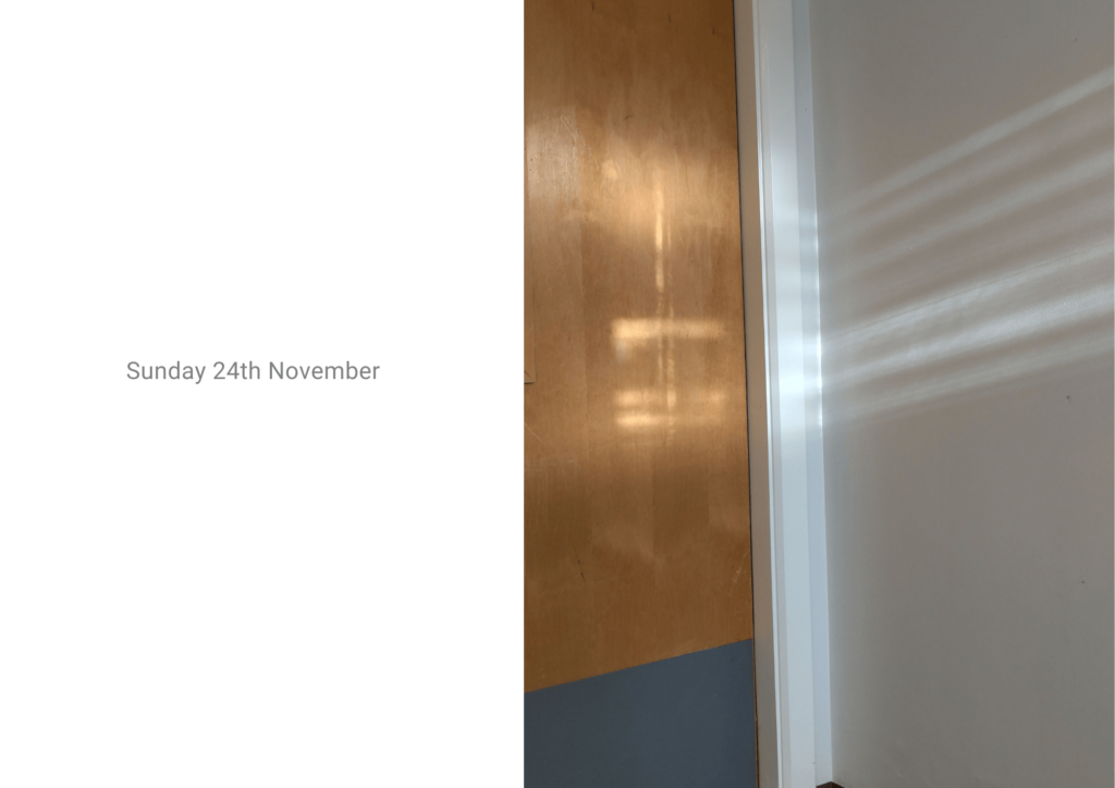 On the right, a photo of sun beams reflecting on a wall and door. On the left words read: "Sunday 24th November"