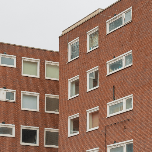Orangey-brown housing estate against a grey sky