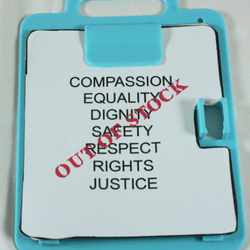 Children's boxed toy in light blue box with transparent panel to see the toys in the middle adapted to represent disability injustice. Wording on the top and bottom of the box in orange letters reads: "Teaching kids about our world" and "disability doll kit".